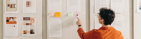 Woman standing in front of white board with resources