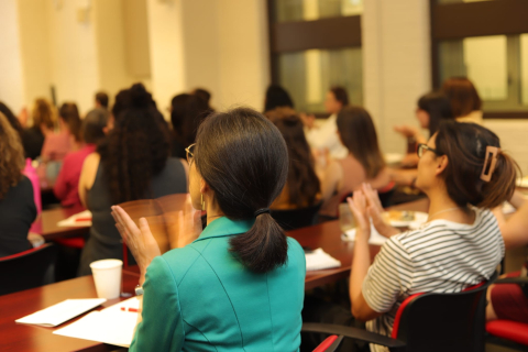 People clapping at a Symposium