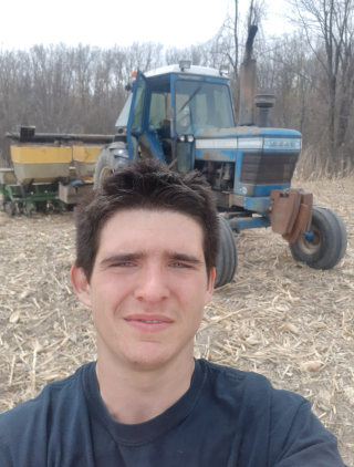 FMT student and FCC award recipient David Billette standing near a tractor