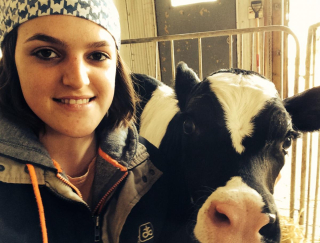 A female student with a cow during her intership.