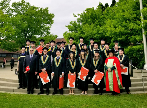 FMT Class of 2019 standing outside with staff following convocation ceremonies at Macdonald Campus