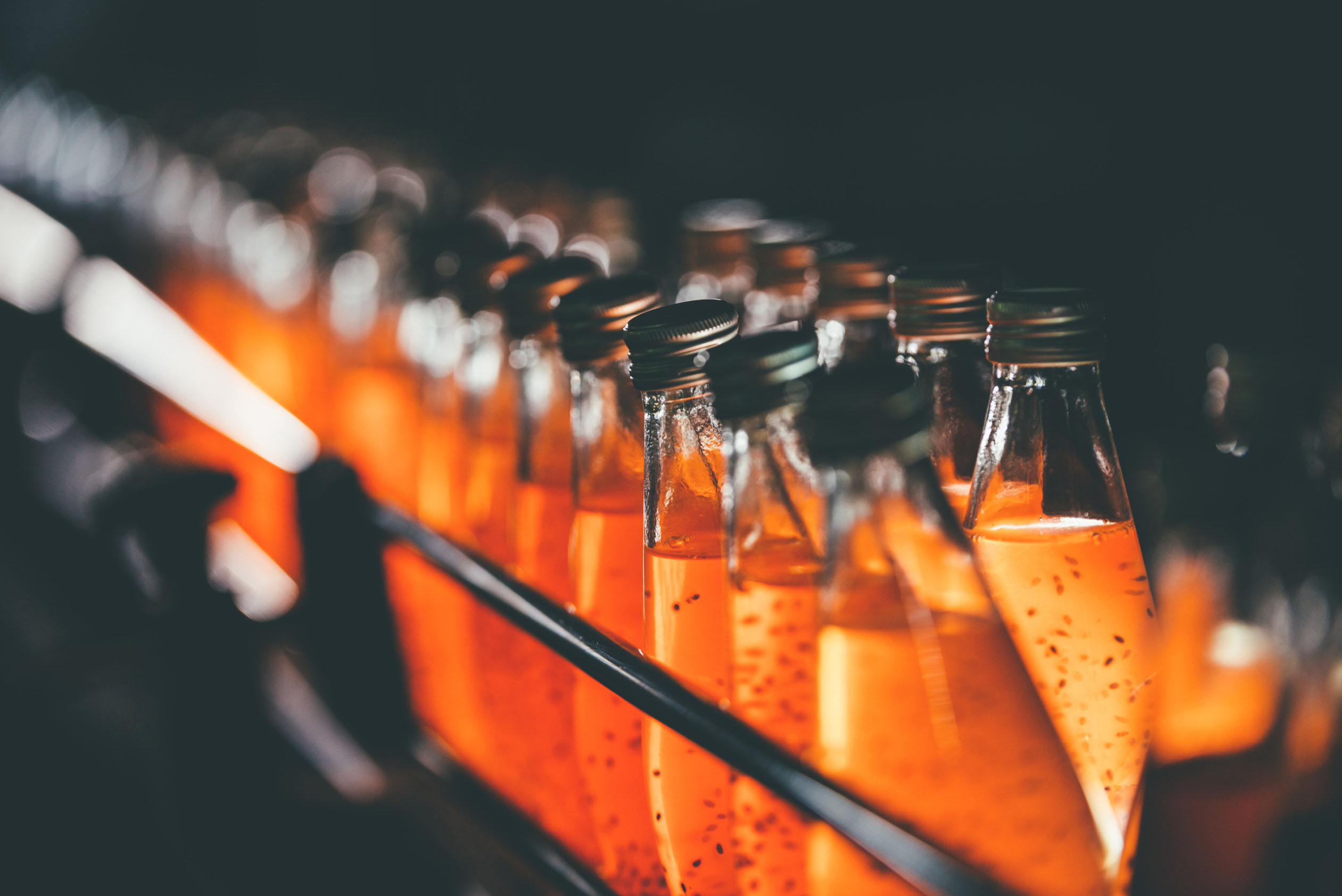 Glass bottles full of orange liquid