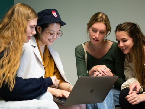 Students crowding around a laptop