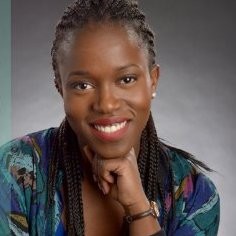 Gertrude Edna Omoro - Black woman wearing her hair in braids wearing a printed blue blouse