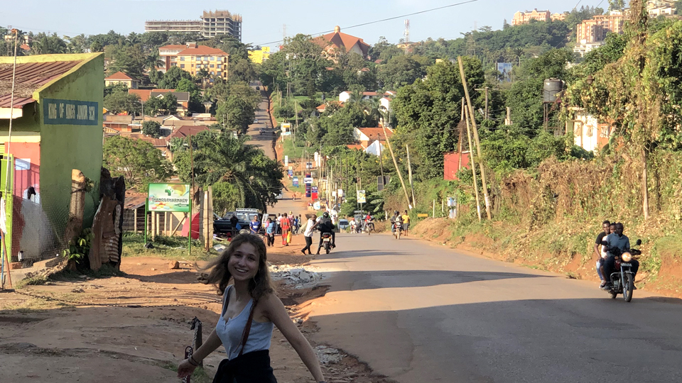 Charlotte Keller walking on a street on location in Uganda