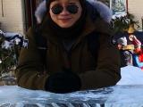 a student in the sunglasses happily smiles at you. Outdoors, snow around