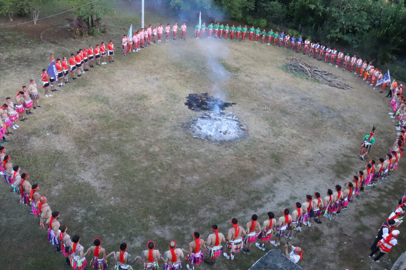 Memorial service: people in a large circle around a fire