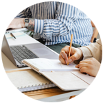 Two people taking notes and working together