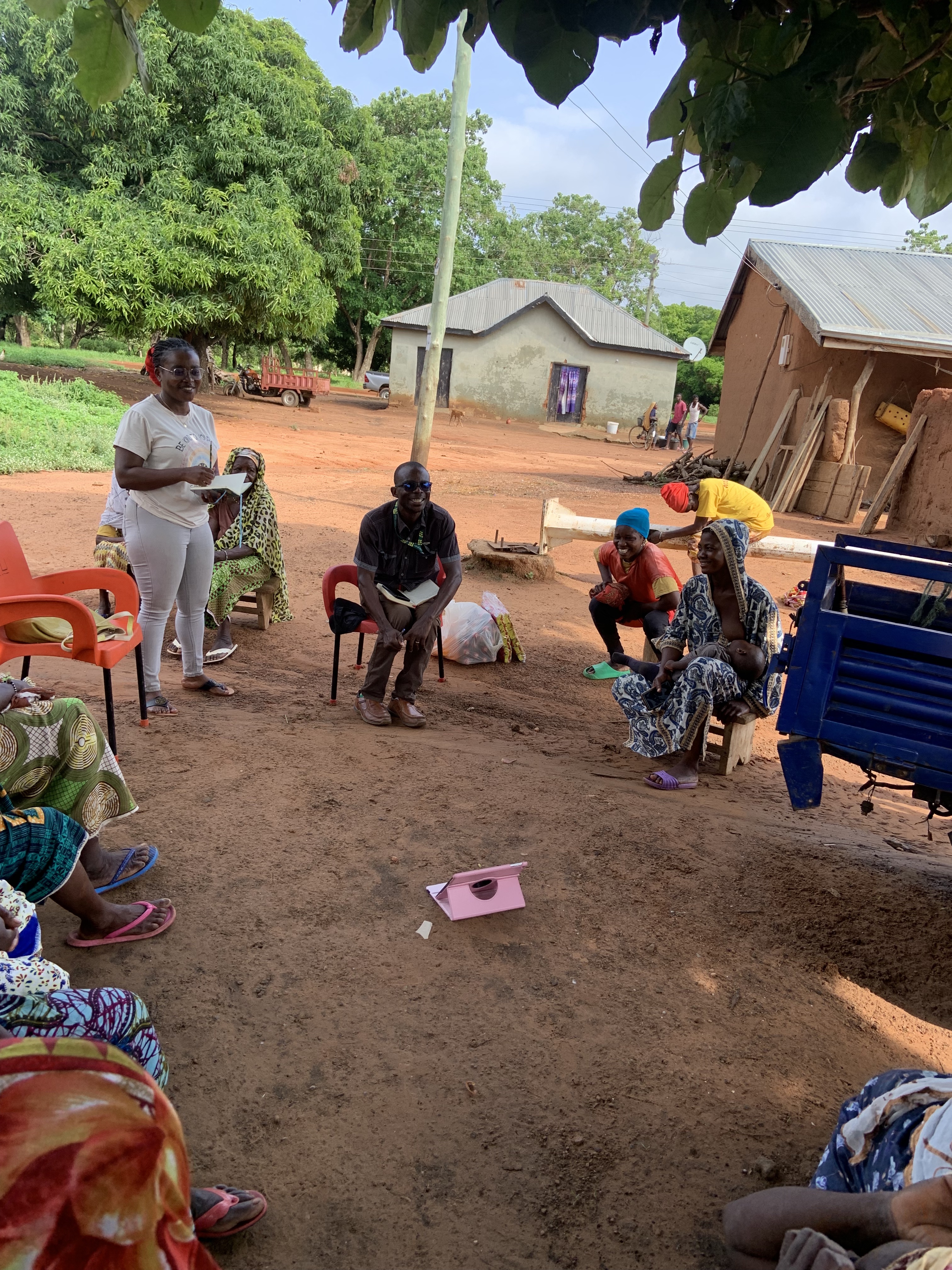 Community members sitting in a circle discussing resource management initiatives