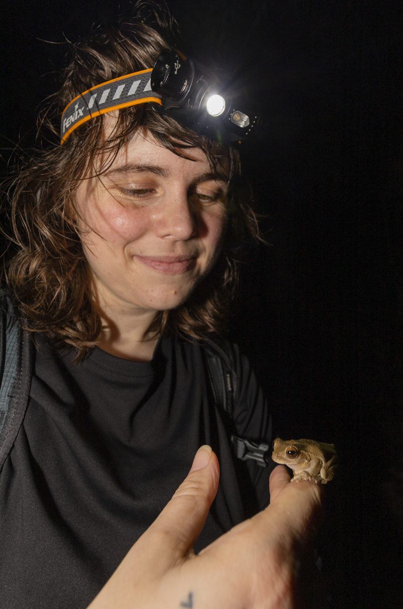 Student holding a frog.