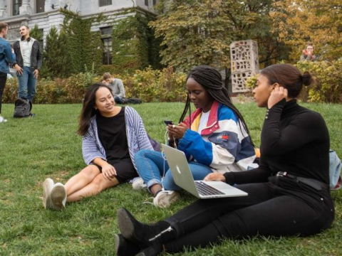 Students sitting on the lawn in front of Redpath Museum