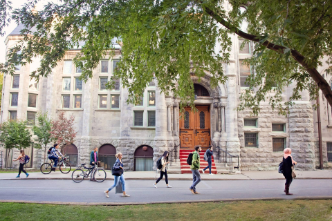 People walk in front of a building