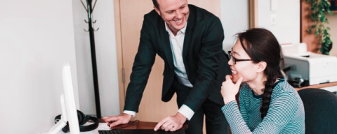 Student and Supervisor discussing in front of a computer screen