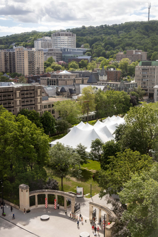 The Convocation tent erected beyond the Roddick Gates, with a view of Mount Royal in the background.