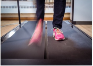 person with pink shoes running on a treadmill