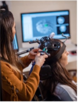 research student working on a neuro-navigated transcranial magnetic stimulation