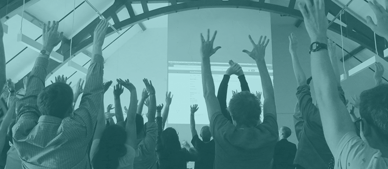 Workshop participants all holding up both of their hands