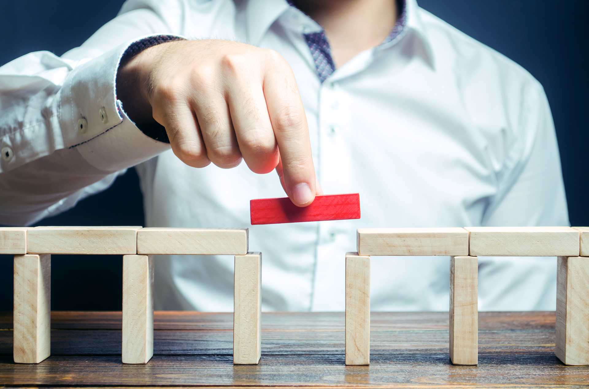 Person building a bridge with wooden pieces