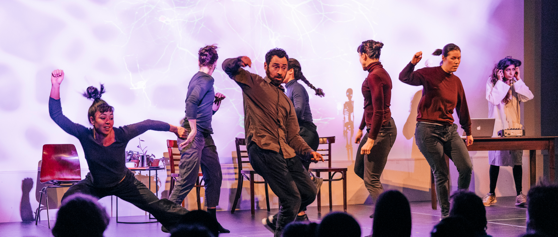 Piece of Mind Collective members performing "The Synaptic Dance" on stage