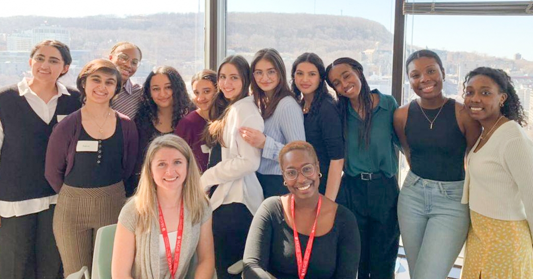 A group of high school students pose for a group photo at the Ingram School of Nursing. A view of McGill campus can be seen in the background. 
