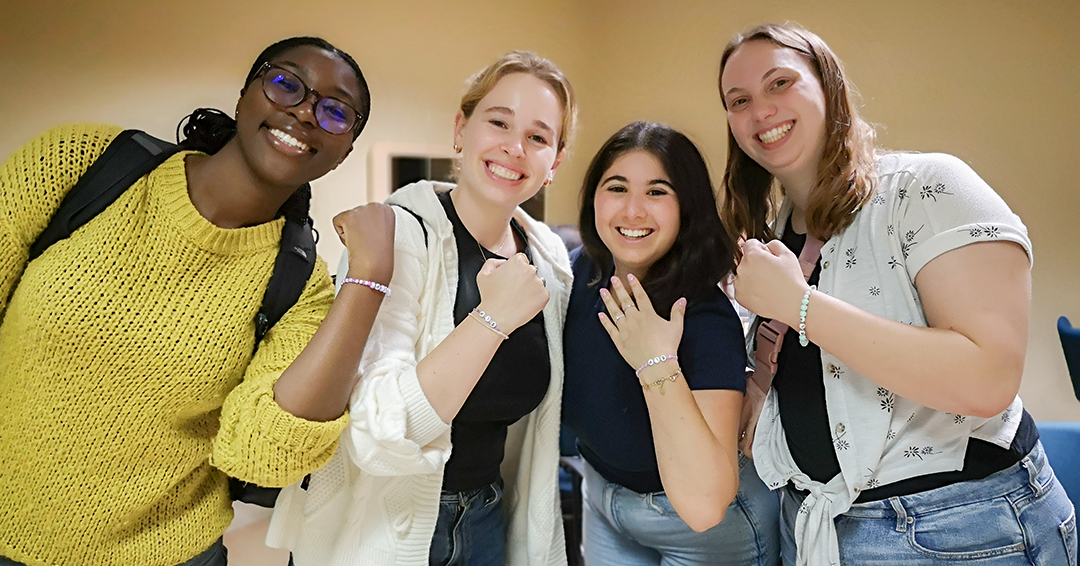 First year SLP students showing friendship bracelets they made at Arts & Crafts Night at the SCSD on September 5 as part of Orientation. 