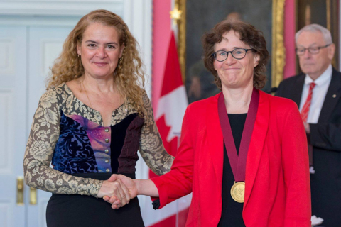 A professor congratulating another at an event