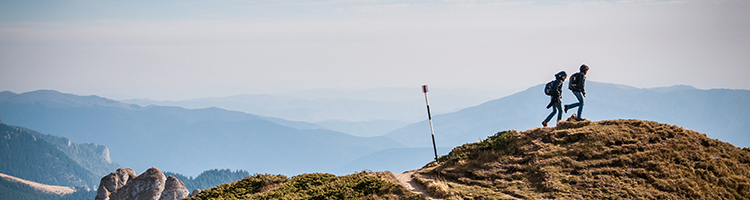 Two people hiking on a mountain