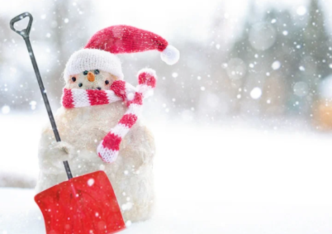 a snowman wearing a Santa hat and a scarf with a red shovel
