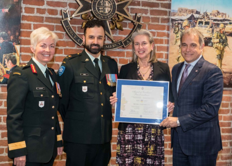 Diana Dutton, Associate Vice-Principal of McGill HR, receiving a certificate on behalf of McGill University from the Canadian Forces Reservists