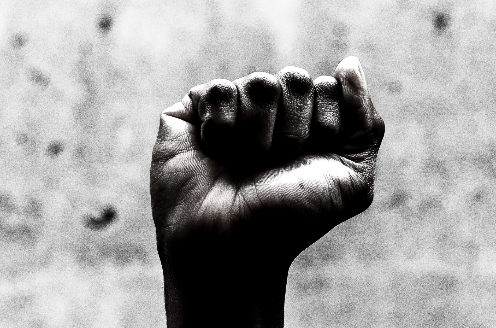 A black hand raised in a fist referring to the civil rights movement 
