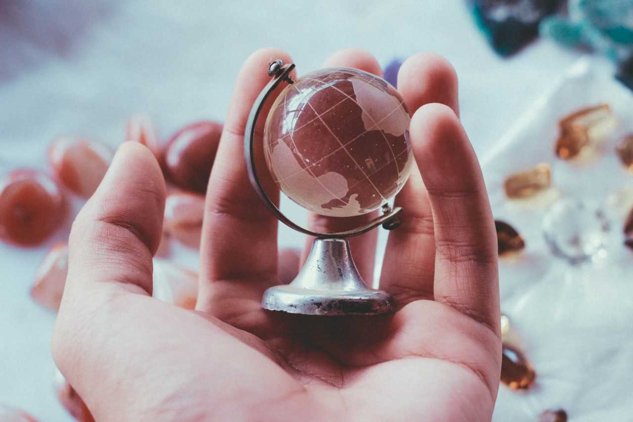 Small etched glass globe in someone's hand