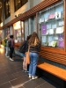 Students looking at the "What's the Recipe for Queer Cookbook" physical exhibit in the hallway of the Leacock building.