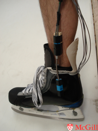 picture of an electrogionemeter placed on the skate (ankle) of a participant in an ice hockey skate