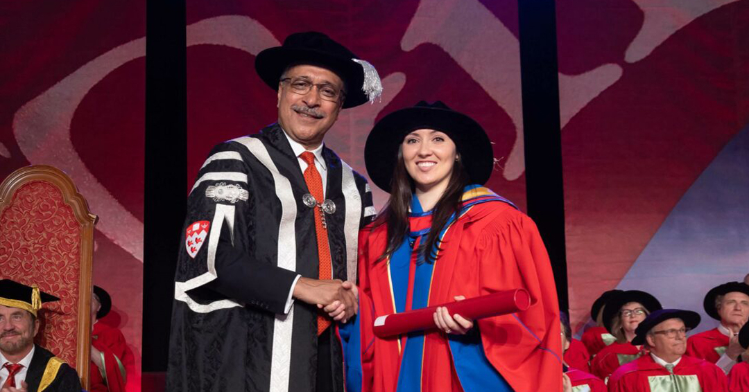 Nicole Ventura, wearing academic regalia, receives the Principal's Prize for Excellence in Teaching - Associate Professor