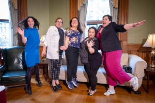 IHSE administration team jumping in front of couch