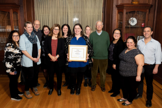Group of faculty and admin staff posing for picture at Ovation Award ceremony