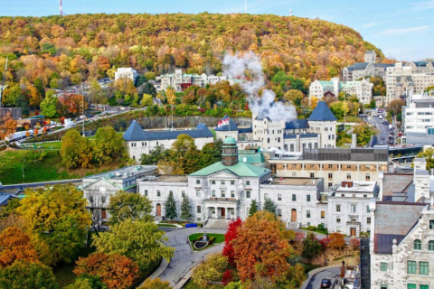 A bird's eye view of McGill campus, showing buildings, trees, and Mount Royal in the background