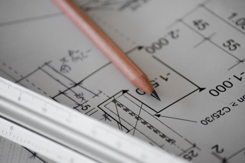 A pencil sits on a planning document with has numbers and lines printed on it.