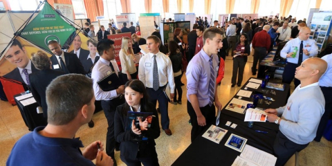 a crowd of people at a job fair