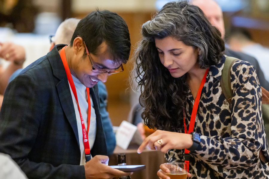 Two people looking at a mobile phone