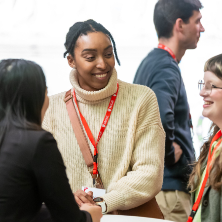 three people talking in a networking setting