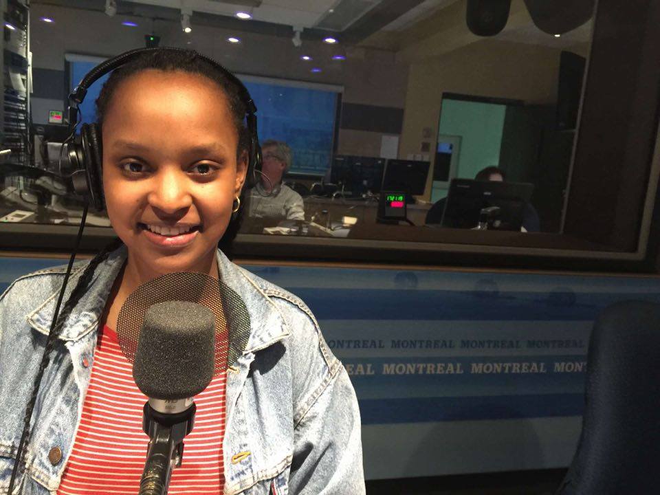 Melissa with headphones and a microphone, hosting a radio show