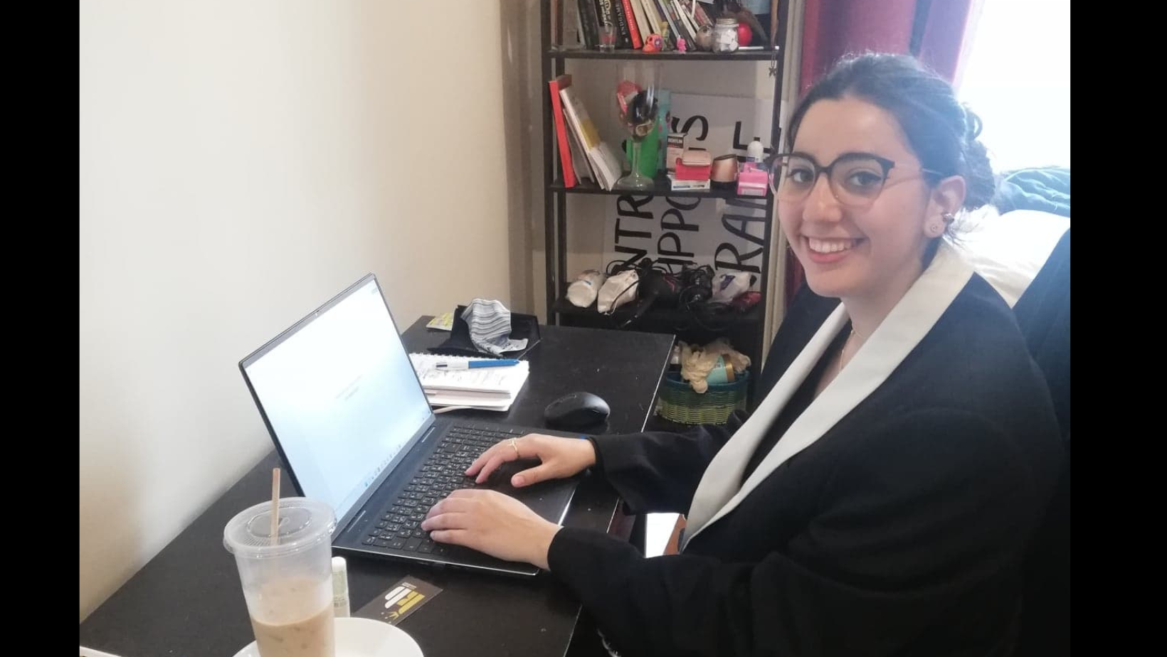 Dounia working at her desk during her internship