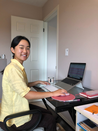 Grace Ma sitting at a desk at home