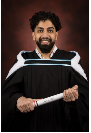 Picture of Hussain Awan in a graduation gown, holding a scroll