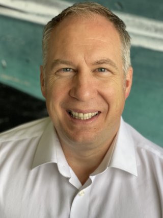 close up photo of Paul Chamberland smiling