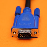 Blue computer device plug on orange background