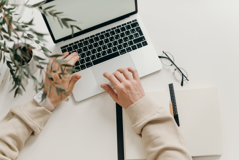 hand typing on laptop keyboard