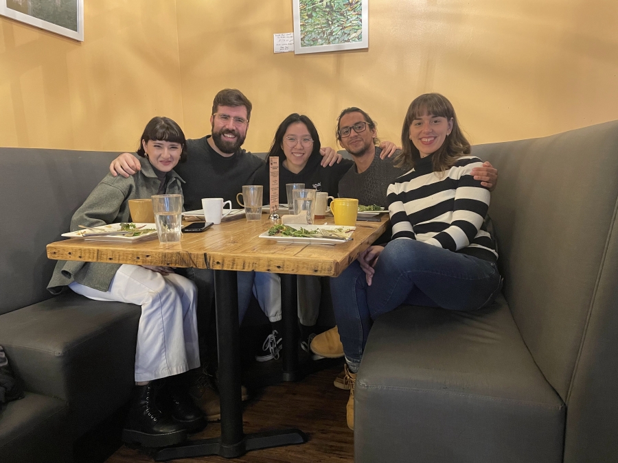 5 people sitting around a restaurant booth table