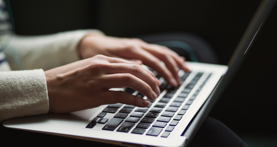 Woman typing on laptop. Photo by Kaitlyn Baker (Unsplash)